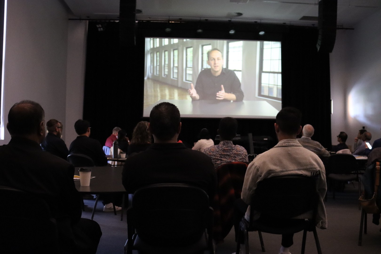 Community members watching a faith-driven entrepreneurship video