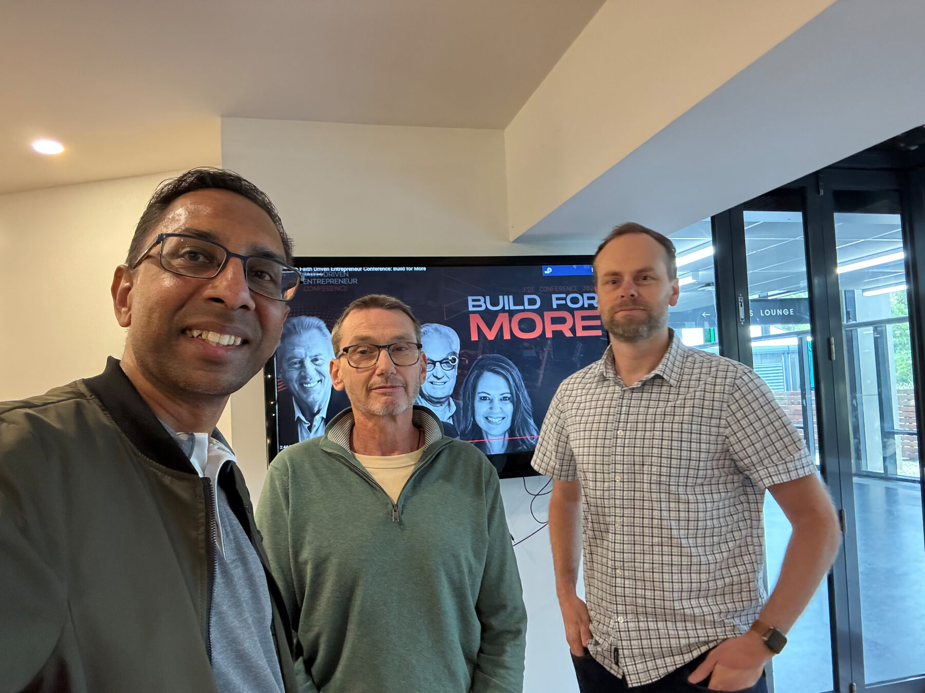 Three community members posing together at a Faith Driven Entrepreneurs gathering